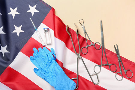 Surgical tools and USA flag on beige backgroundの写真素材