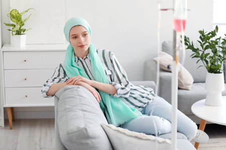 Teenage girl undergoing chemical therapy course at homeの写真素材