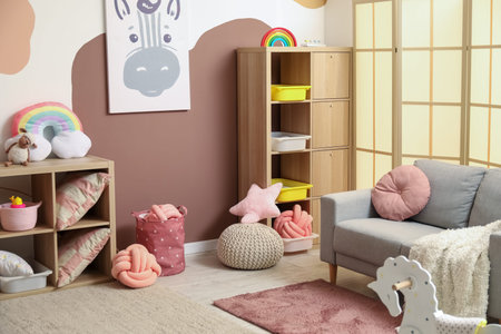 Interior of children's room with sofa, drawers and toys