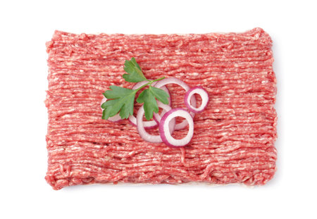 Fresh minced meat with parsley and onion rings isolated on white background