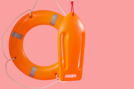 Ring buoy with board on pink background