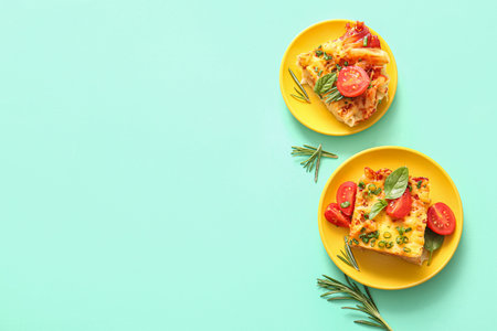 Plates of pasta with tomato sauce and cheese on turquoise background