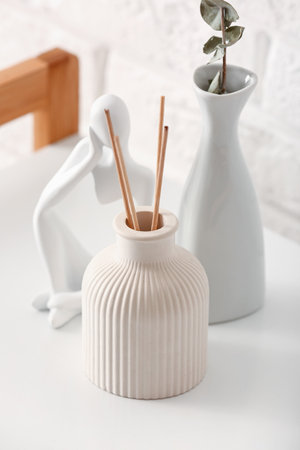 Bottle of reed diffuser and decor on table, closeupの写真素材