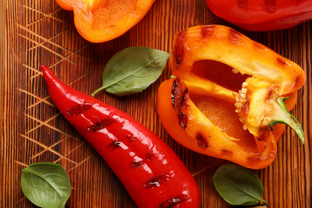Tasty grilled peppers on table