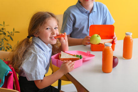 Little children eating lunch at schoolの写真素材