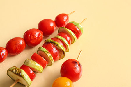 Skewers with tasty grilled vegetables on yellow backgroundの写真素材