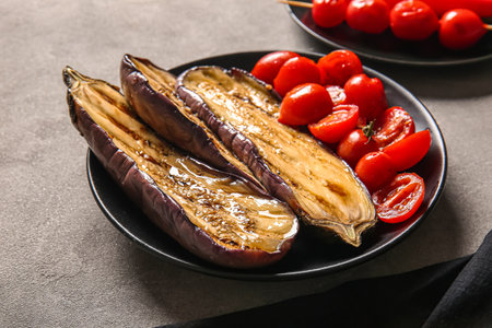 Plate with tasty grilled vegetables on gray backgroundの写真素材