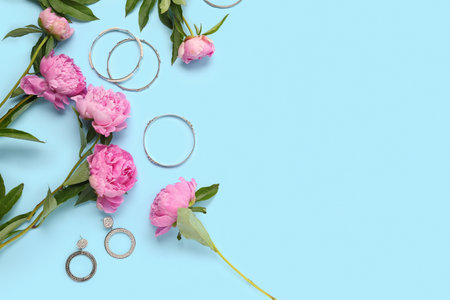 Composition with beautiful peony flowers and stylish female accessories on color backgroundの写真素材