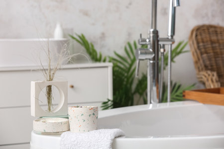 Holders with candles and towels on bathtub in bathroom, closeupの写真素材