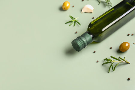 Bottle of olive oil on green backgroundの写真素材