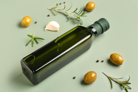 Bottle of olive oil on green backgroundの写真素材