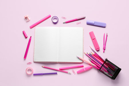 Notebook with different school stationery on lilac backgroundの写真素材
