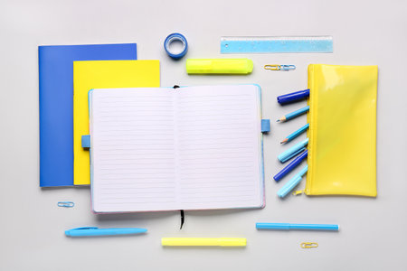 Notebooks with pencil case and different school stationery on white backgroundの写真素材