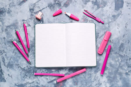 Notebook with different stationery on grunge blue backgroundの写真素材