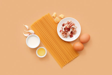 Ingredients for tasty pasta carbonara on beige backgroundの写真素材
