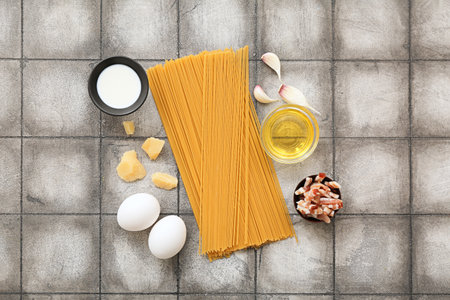 Ingredients for tasty pasta carbonara on tile backgroundの写真素材