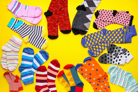 Frame made of different cotton socks on yellow backgroundの写真素材