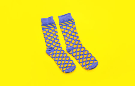 Pair of stylish socks on yellow backgroundの写真素材
