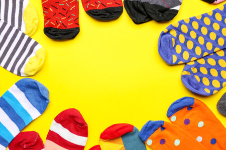 Frame made of different cotton socks on yellow background, closeupの写真素材