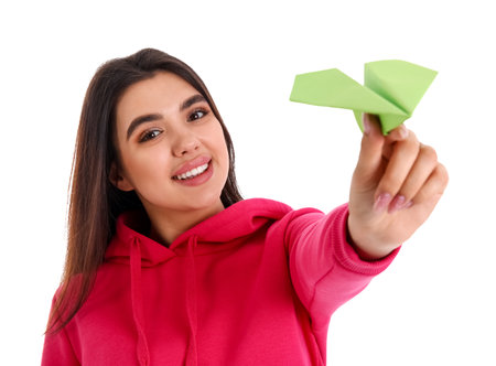 Young woman with paper plane on white background, closeupの写真素材