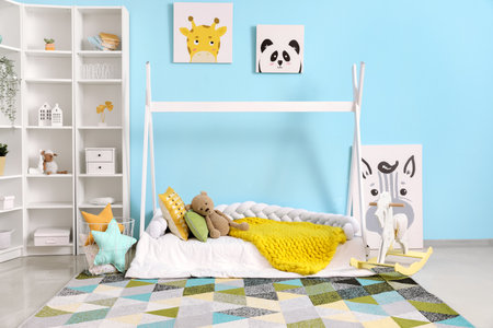 Interior of children's room with bed, shelving unit and toysの写真素材