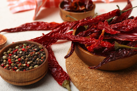 Composition with dry hot chili peppers and spices on white backgroundの写真素材
