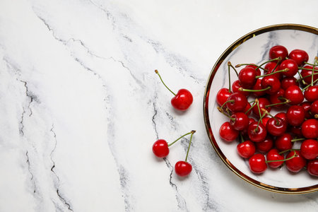 Plate with sweet cherry on white backgroundの写真素材