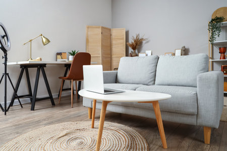Interior of living room with sofa and workplaceの写真素材