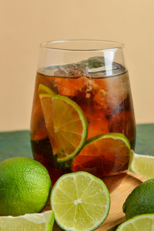 Glass of cold Cuba Libre cocktail on tableの写真素材
