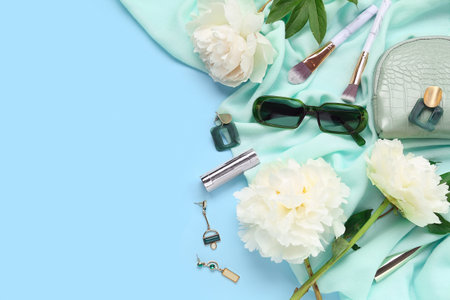 Composition with stylish female accessories, cosmetics and beautiful peony flowers on color backgroundの写真素材
