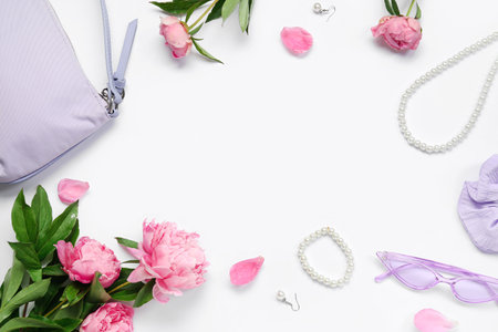Frame made of stylish female accessories and beautiful peony flowers on white backgroundの写真素材