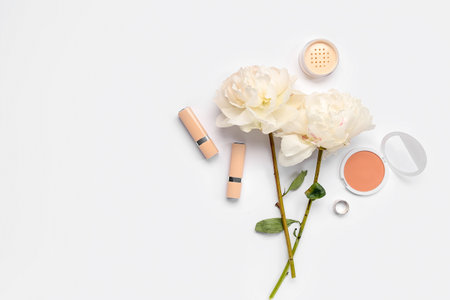 Composition with cosmetics and beautiful peony flowers on white backgroundの写真素材