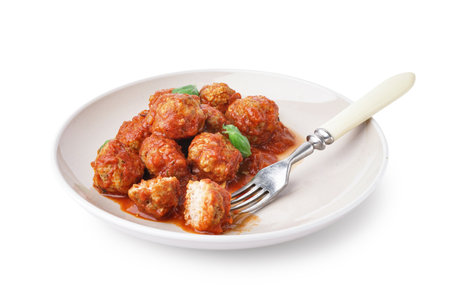 Plate of tasty meat balls with tomato sauce and basil on white backgroundの写真素材