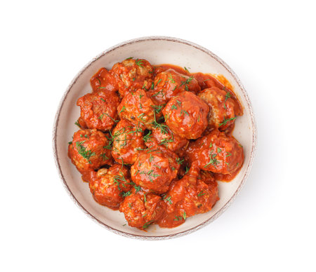 Bowl of tasty meatballs with sauce on white backgroundの写真素材