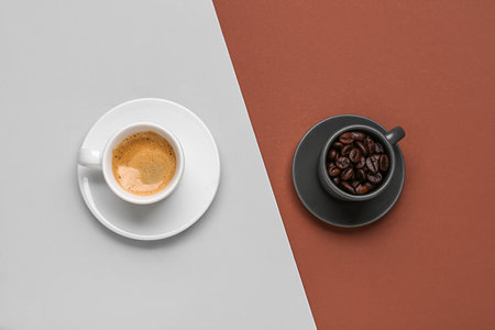 Cups of hot espresso and coffee beans on color backgroundの写真素材