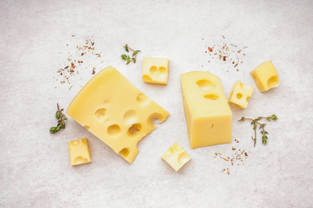 Pieces of Swiss cheese on white backgroundの写真素材