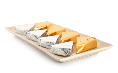 Plate with triangles of tasty processed cheese on white backgroundの写真素材