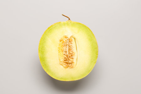 Half of sweet melon on gray backgroundの写真素材