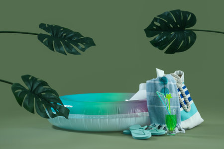 Inflatable ring with cocktail, palm leaves and beach accessories on green background. travel conceptの写真素材