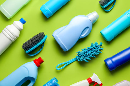 Many different cleaning supplies on green backgroundの写真素材