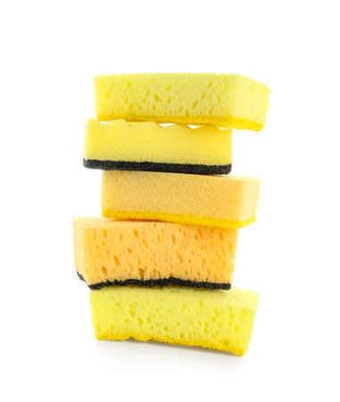Stack of yellow sponges isolated on white backgroundの写真素材