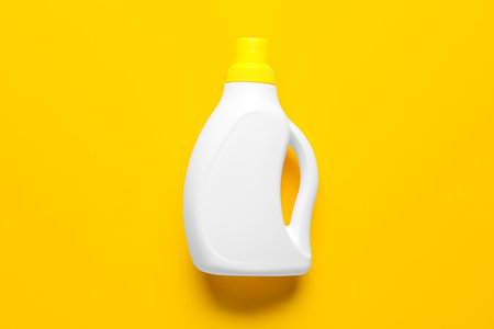 Bottle of detergent on orange backgroundの写真素材