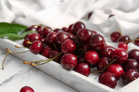 Tray with sweet cherry on white backgroundの写真素材