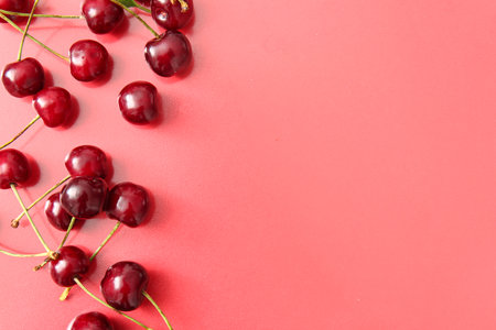Many sweet cherries on red backgroundの写真素材