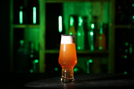 Glass of fresh beer on table in barの写真素材
