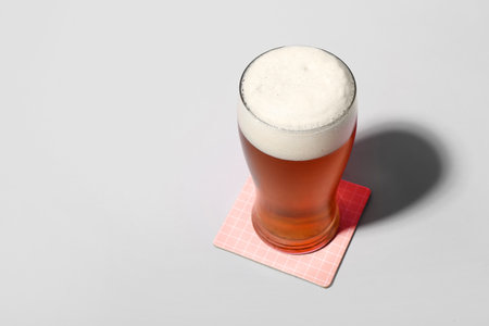 Glass of cold beer on light backgroundの写真素材