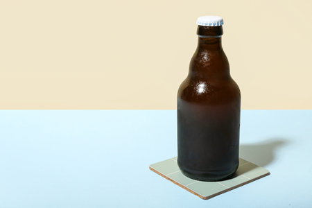 Bottle of cold beer on color backgroundの写真素材