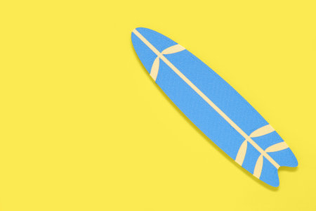 Mini surfboard on yellow backgroundの写真素材