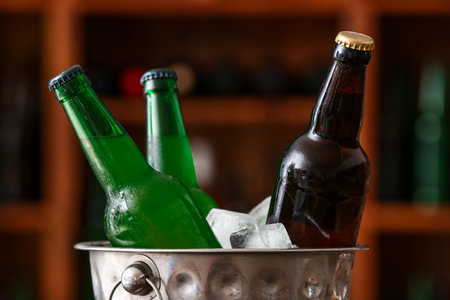 Bucket with bottles of cold beer in bar, closeupの写真素材