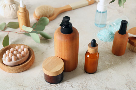 Bottles of cosmetic products, massage soap and cream on light backgroundの写真素材